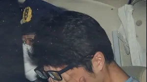 Takahiro Shiraishi covers his face inside a police car in Tokyo
2017